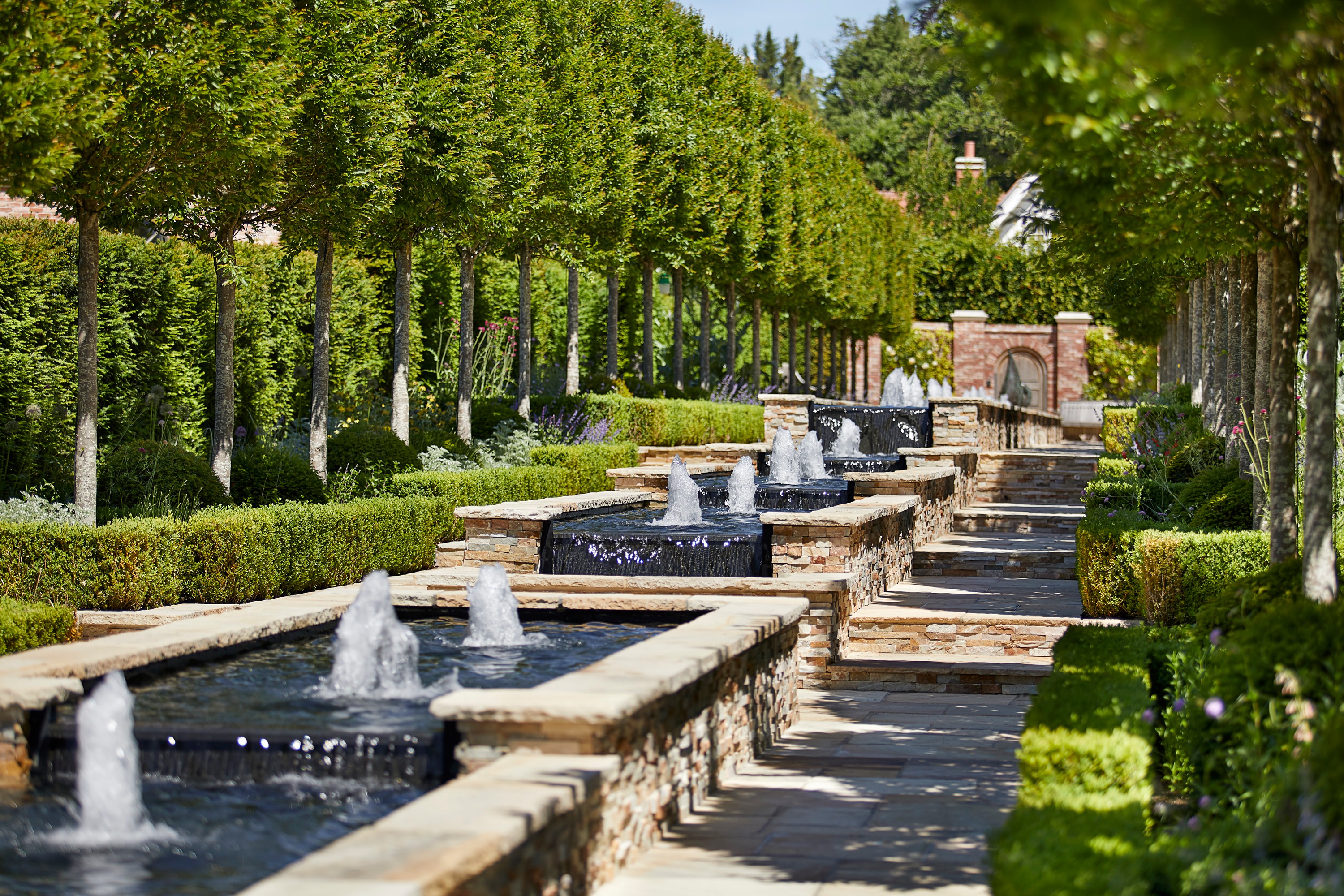 Client portfolio photograph: tree-lined fountains in the Cheval gardens